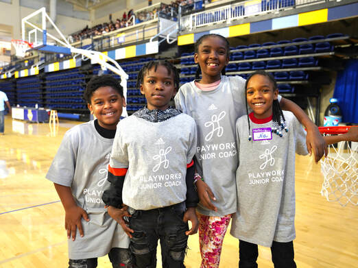 Four students in a gymnasium