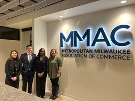Group photo in front of MMAC sign